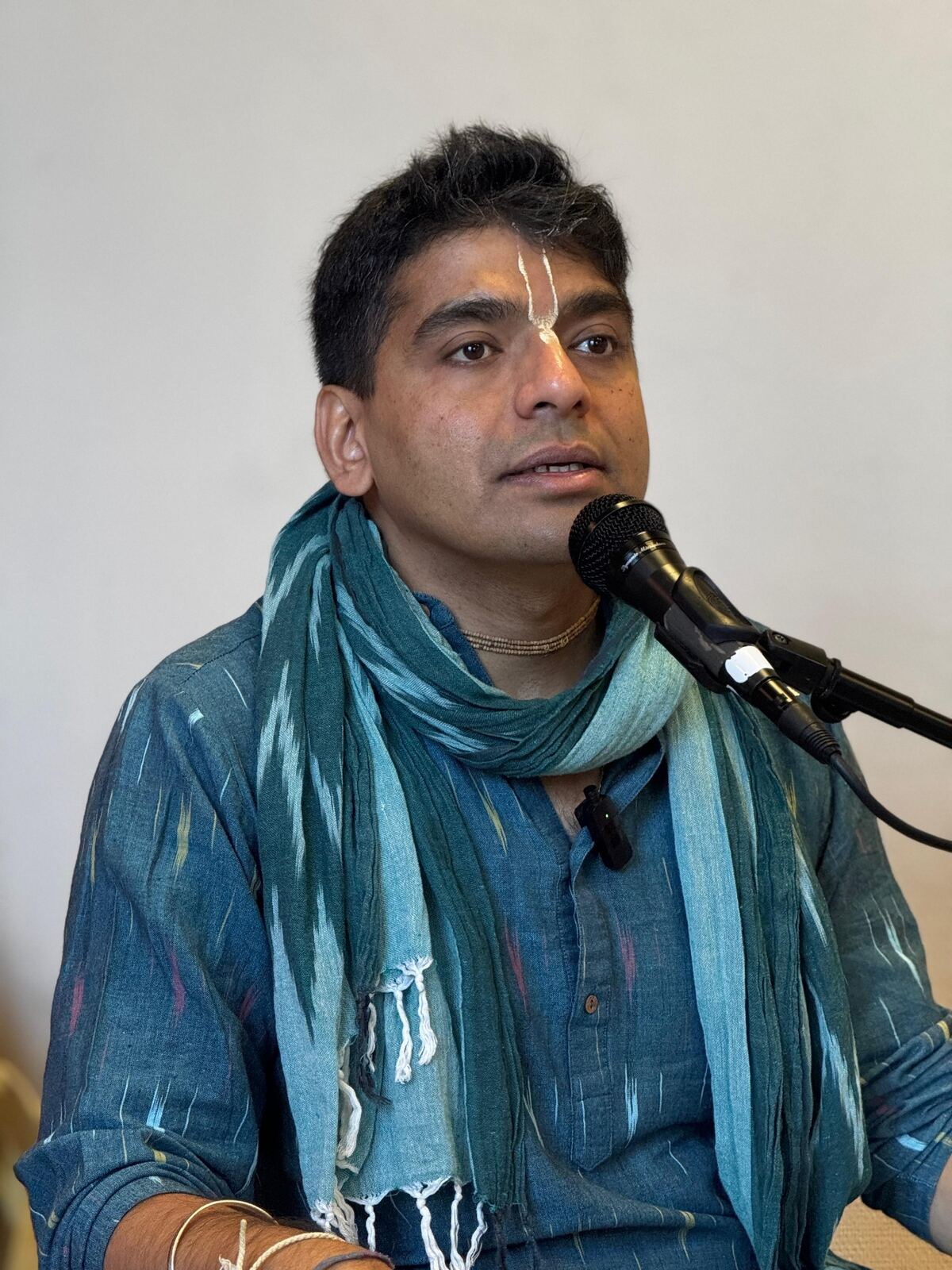 Dr. Raj Hegde speaking with a microphone